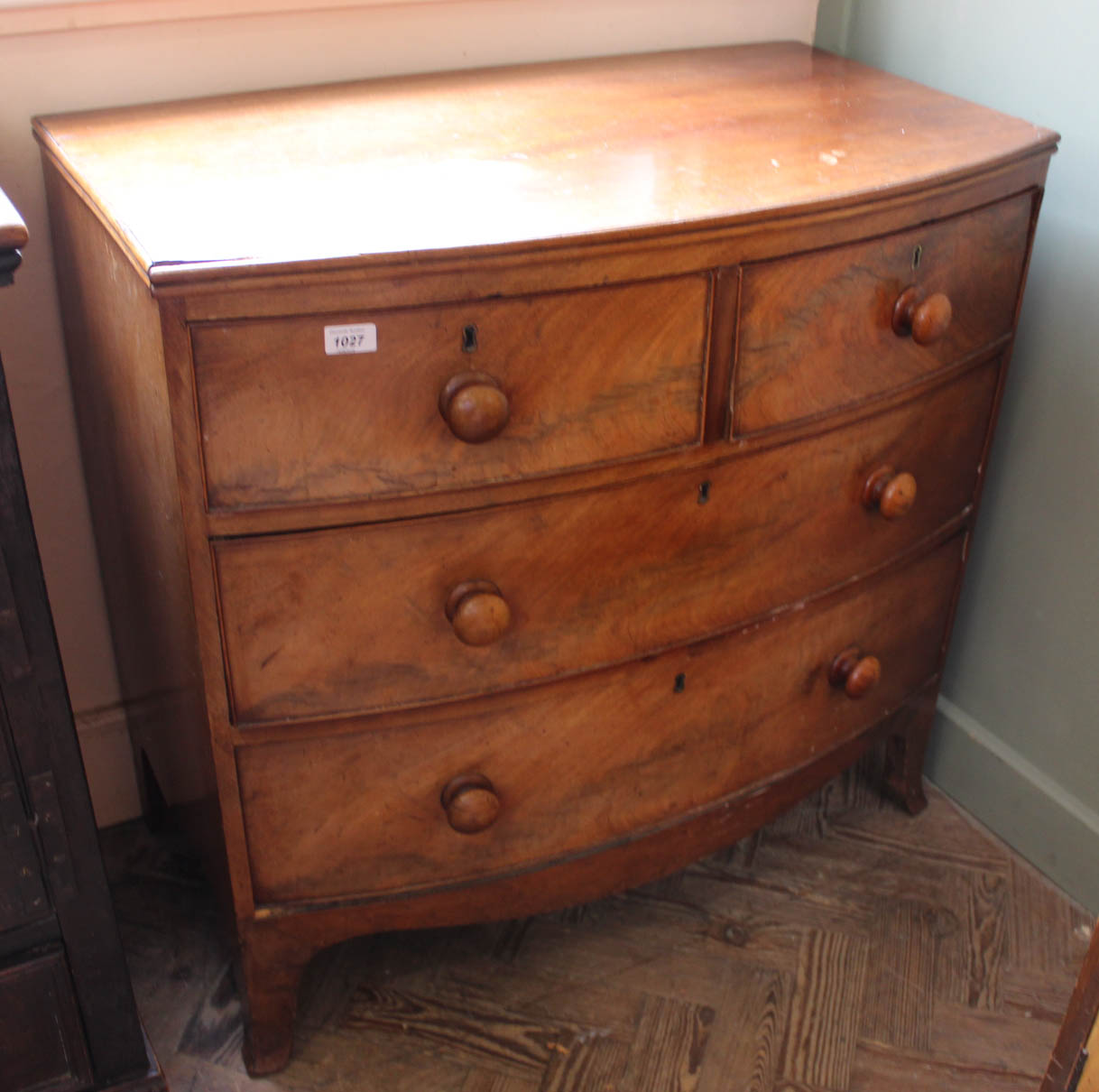 An early Victorian mahogany four drawer bow front chest with original knobs,