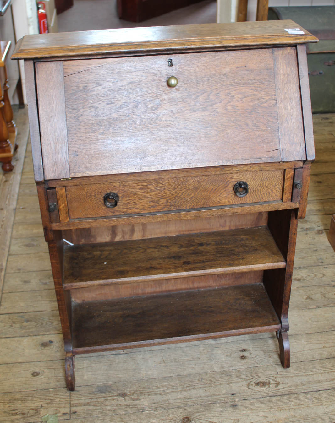 An Arts and Crafts oak narrow desk with one drawer,