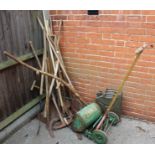 A selection of good quality gardening tools and lawn mower and petrol can