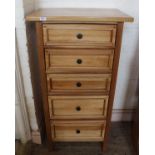 A modern hardwood five drawer chest with metal handles