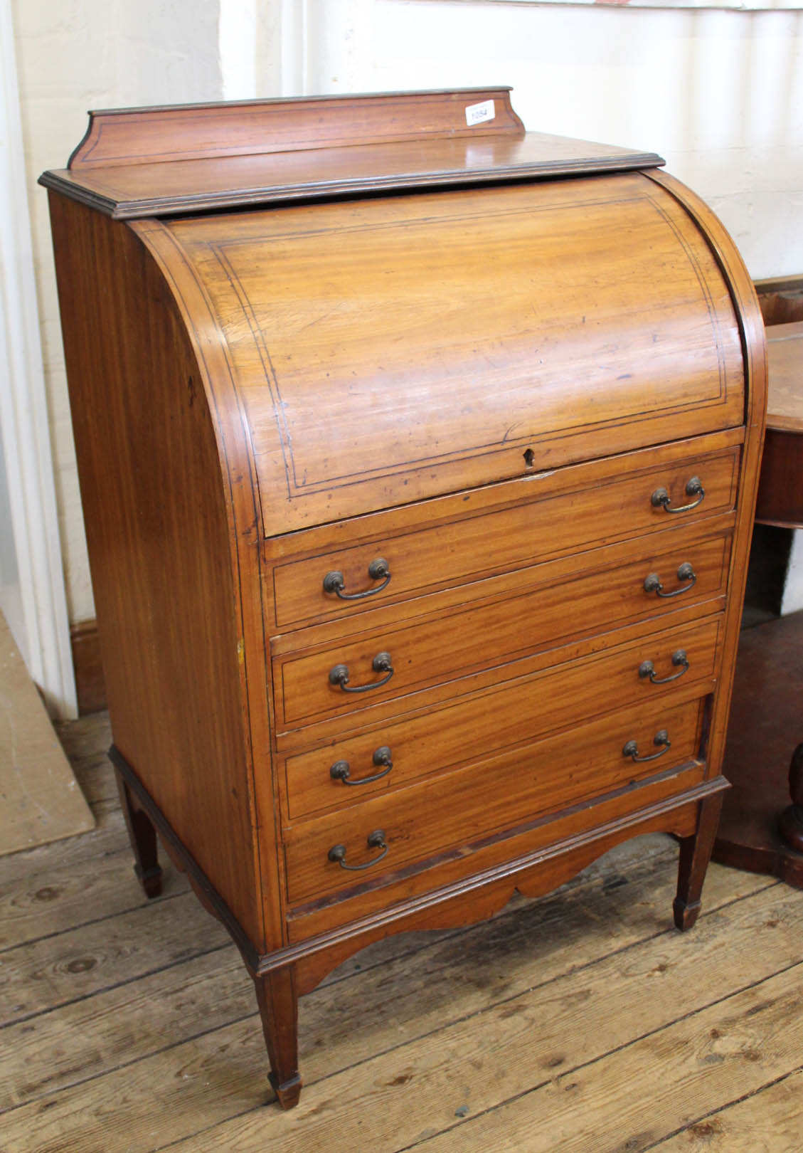 An Edwardian inlaid satinwood small roll top desk with four drawers