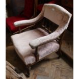 An Edwardian mahogany low arm chair with pink upholstery