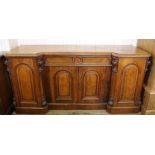 A substantial four door Victorian carved oak shaped front sideboard with single drawer
