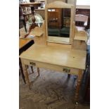 A lined oak Edwardian dressing table on original porcelain castors