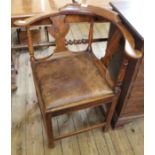 A Victorian oak corner chair with leather upholstered seat