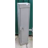 A one door metal cabinet with lock and key