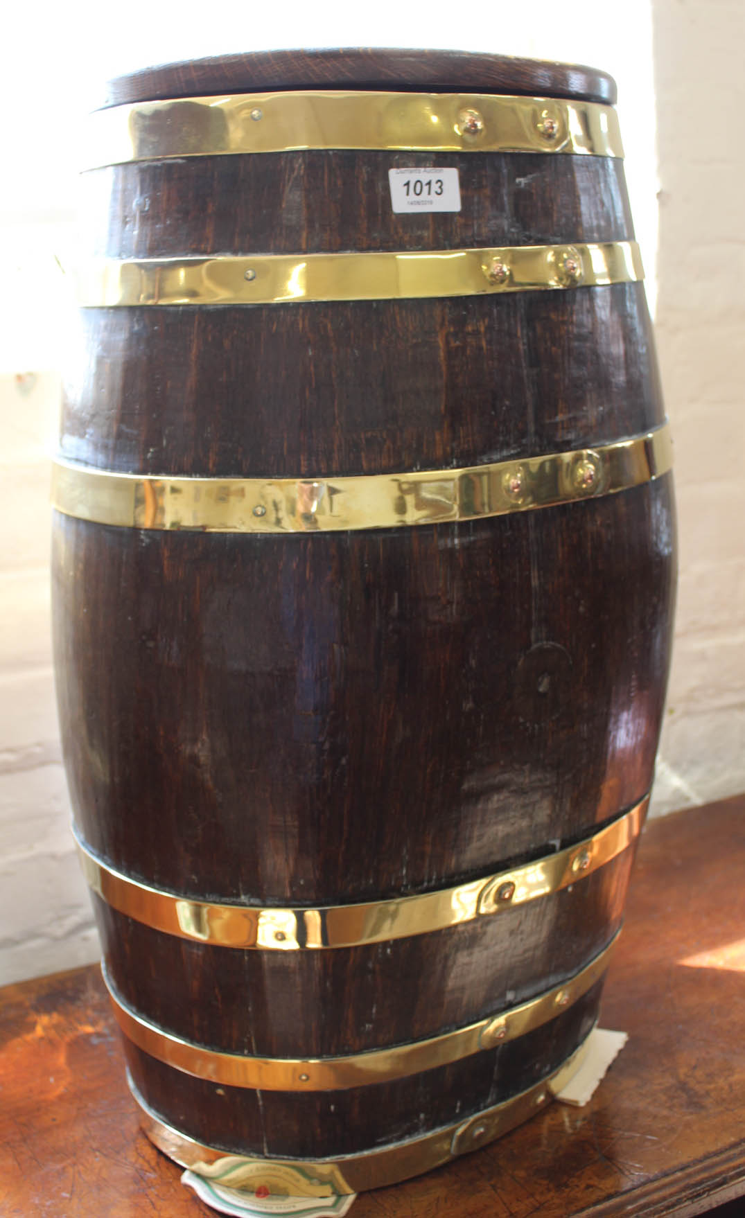 An ornamental oak and brass bound lidded barrel