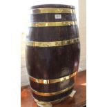 An ornamental oak and brass bound lidded barrel