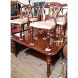 A reproduction mahogany dining table with four chairs