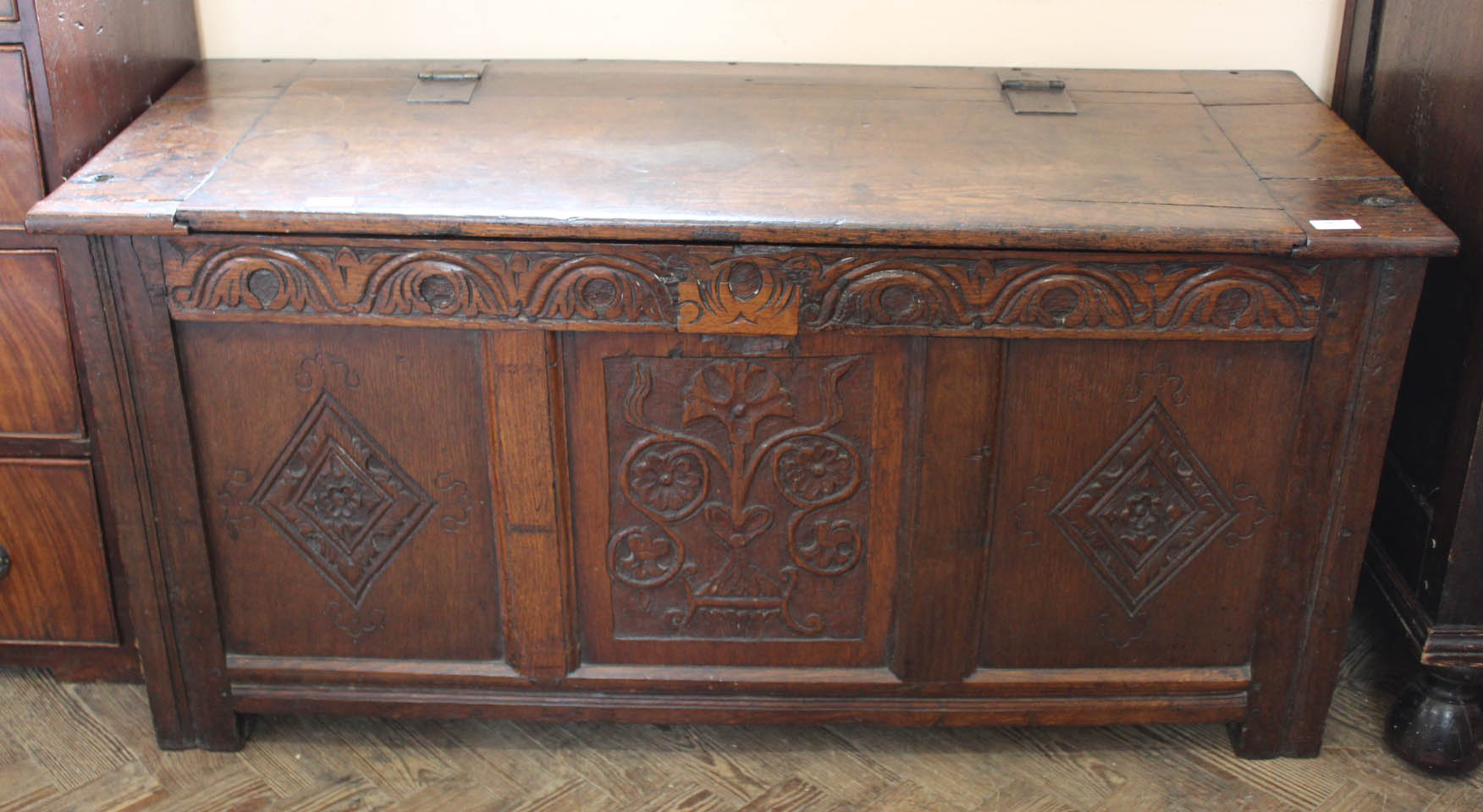 An 18th Century carved oak coffer with part hinged lidded top