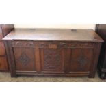 An 18th Century carved oak coffer with part hinged lidded top