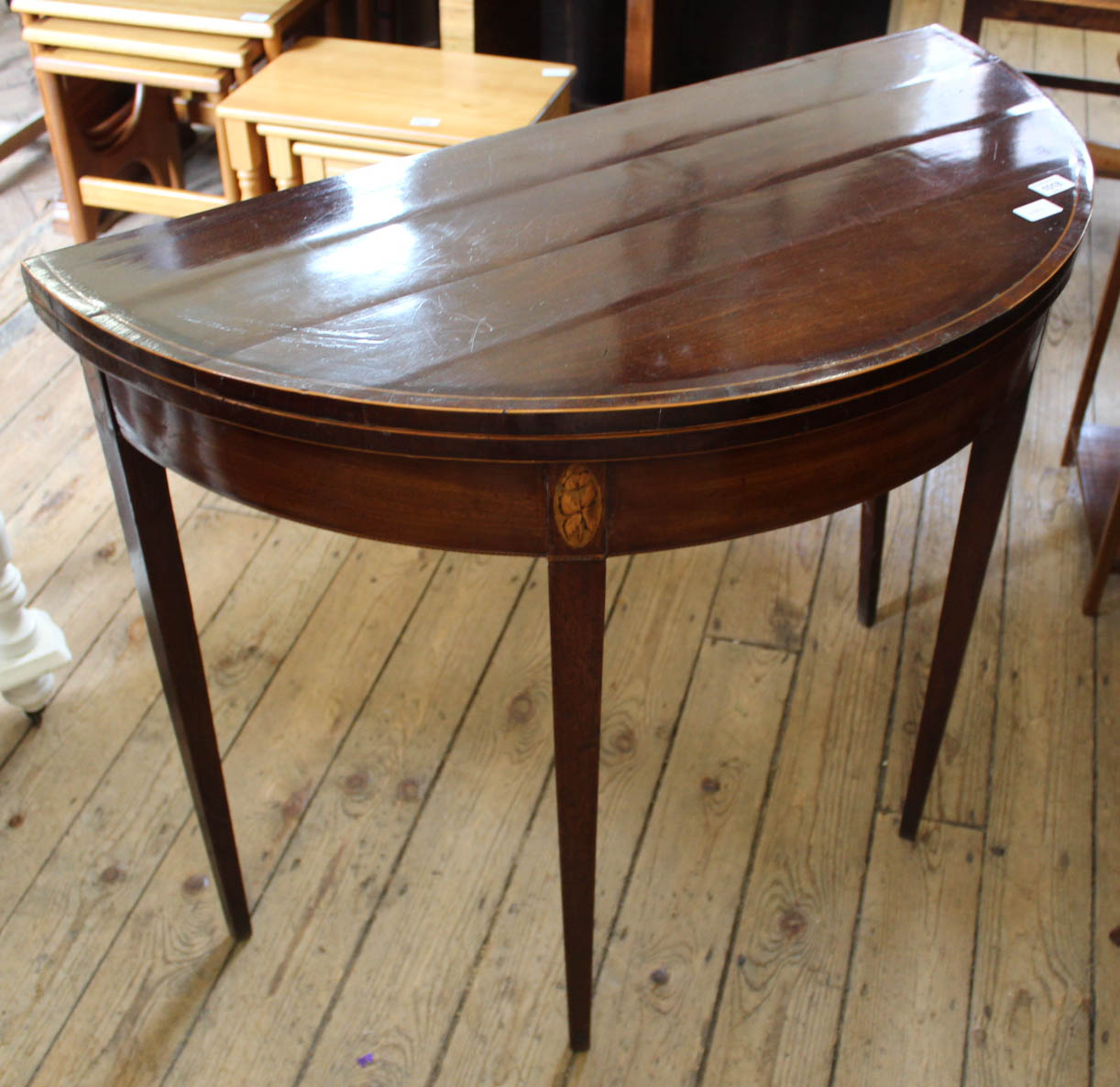 A 19th Century mahogany card table on square tapered legs