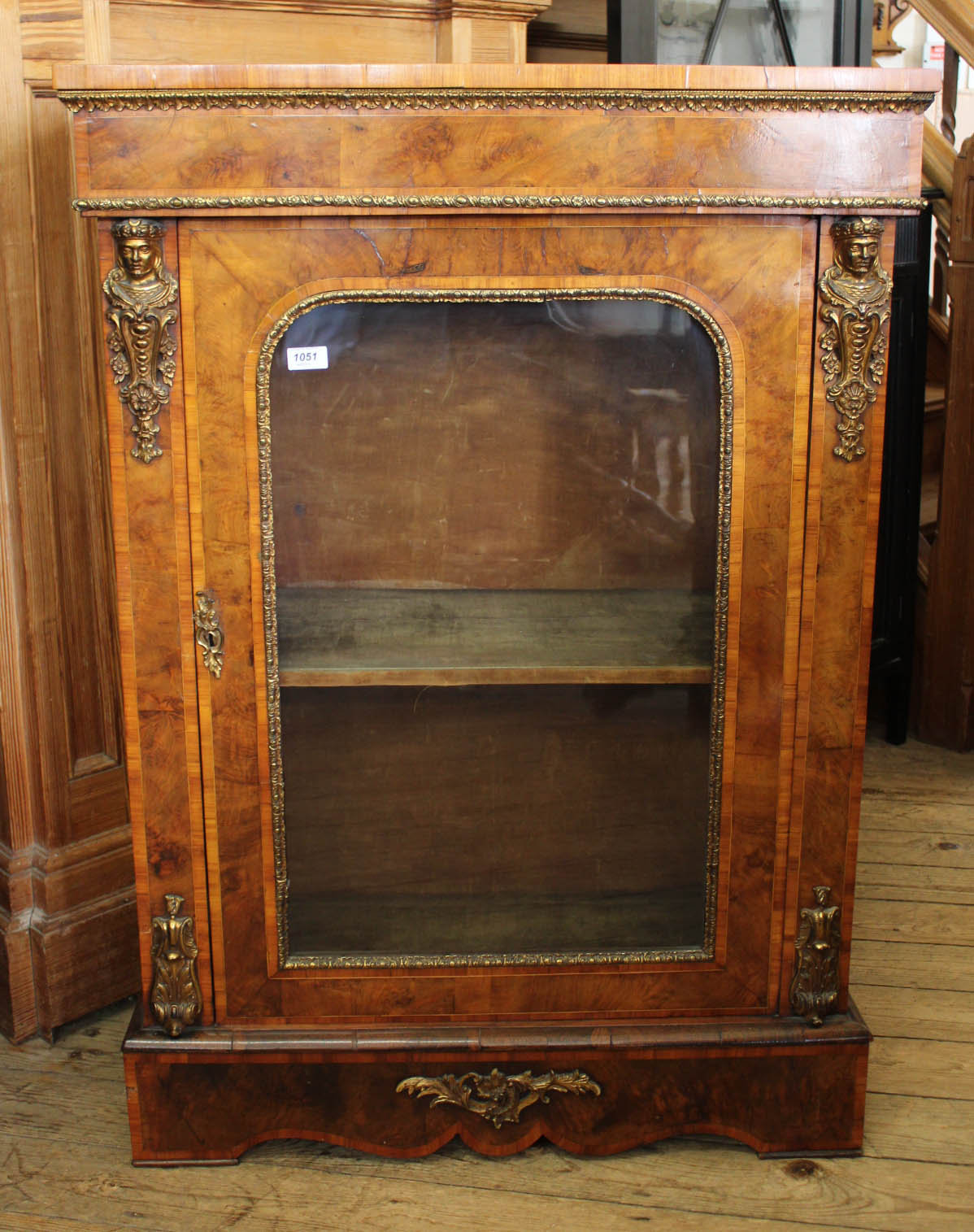 A 19th Century French burr walnut pier cabinet with gilt decoration