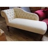 A modern cream upholstered chaise longue of small proportions