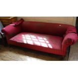 A substantial Chesterfield standing on original brass castors with red check upholstery
