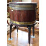 A Georgian mahogany brass bound oval wine cooler with original tray and castors