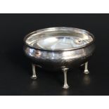 A silver planished sugar bowl on four elongated feet by A E Jones,