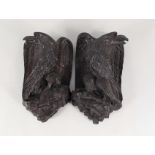 A pair of 19th Century carved oak eagle wall plaques,