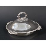 A silver muffin dish with ribbed decoration to border,