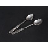 A pair of silver Liberty & Co teaspoons with engraved decoration