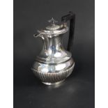 A silver half fluted water jug,