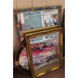 An oval wall mirror with simulated peacock inlays plus two rectangular mirrors