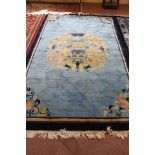 A Chinese blue ground dragon decorated rug,