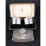 A cased pair of silver napkin rings,