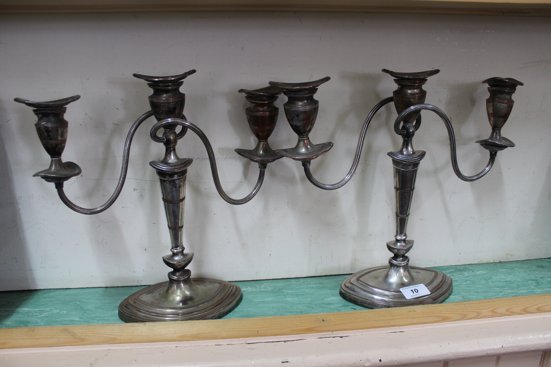 A pair of 19th Century Adam style three light silver plated on copper candelabra with reeded