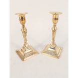 A pair of early 19th Century brass candlesticks