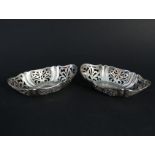 A pair of ornately pierced silver dishes