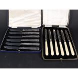 A boxed set of six silver bladed ivory butter knives and a cased set of six silver handled