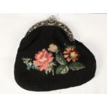A lady's wool work reticule with continental white metal floral frame and clasp