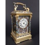 A French gilt metal and champleve enamel striking carriage clock