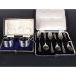 A cased pair of silver napkin rings and a box set of six silver teaspoons