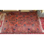 An Afghan red ground floral rug,