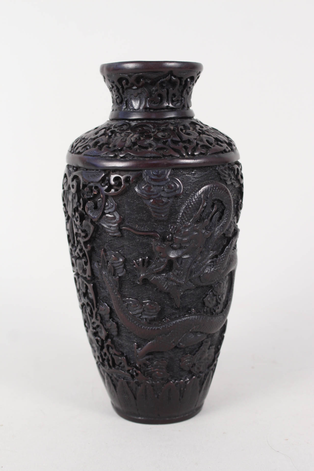 A Chinese cast moulded vase with relief dragon decoration,