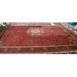 A large machine made red ground Persian pattern floral carpet,