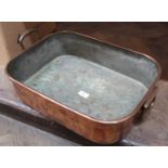 A heavy 19th Century oblong twin drop handled seamed copper roasting pan stamped 'Patterson Late