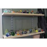 A large quantity of glass paperweights (two trays)