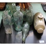 A Coronation glass plate, bottles, stoneware foot warmer,