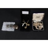 A 9ct gold necklace with two pendants, a silver filigree butterfly brooch,