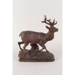 A Black Forest carved wooden stag,