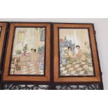 A pair of Chinese wooden two fold table screens with erotic porcelain panels