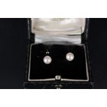 A pair of 9ct gold single pearl set earrings