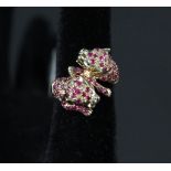 A 9ct gold double leopard ring set with red and green stones,