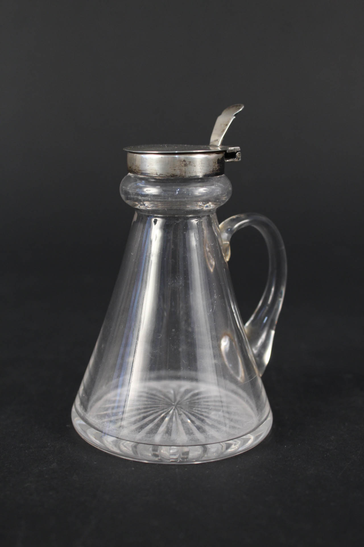 A silver topped cut glass whisky noggin,