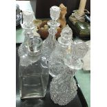 A set of three cut glass decanters plus two others