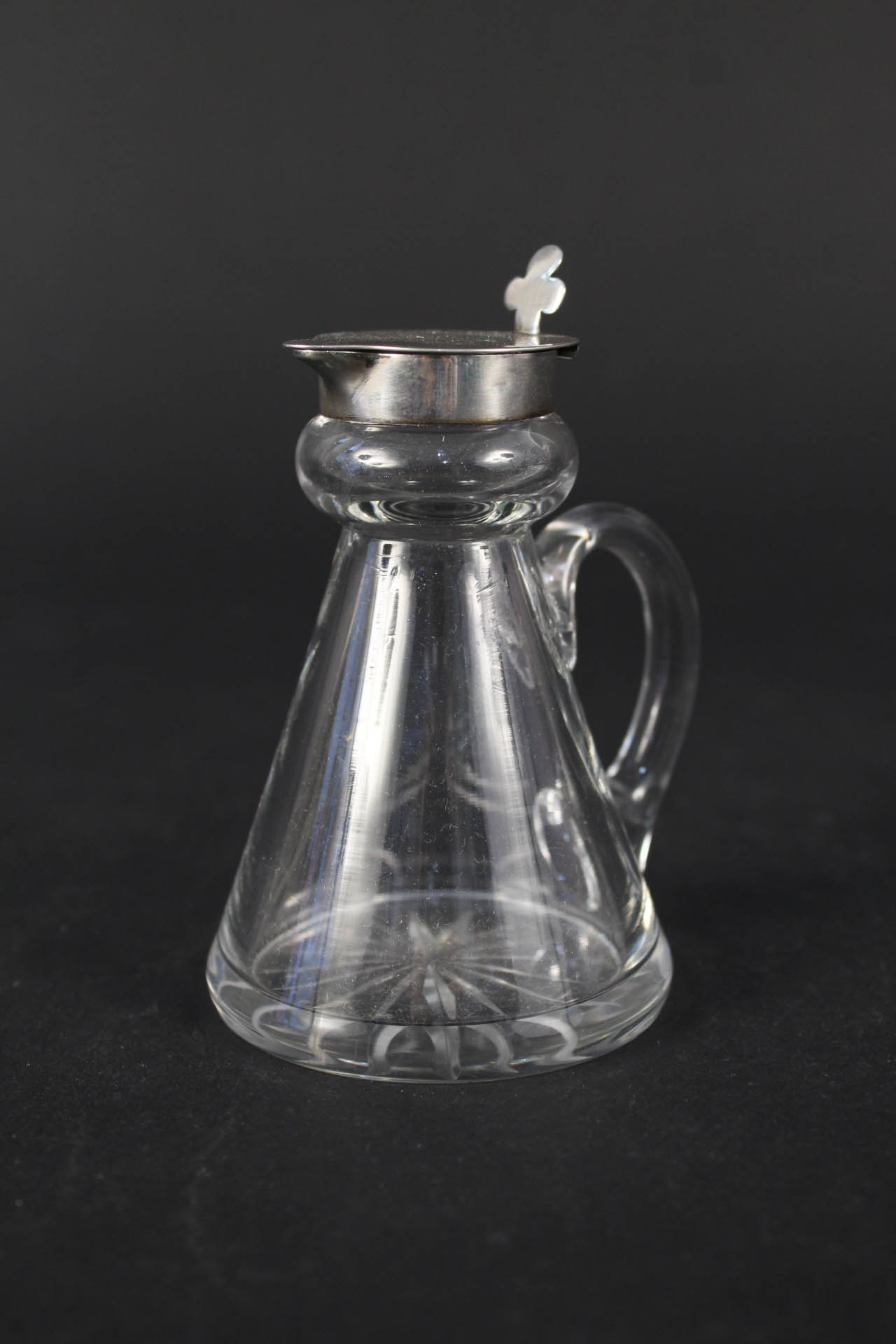 A silver topped glass whisky noggin,