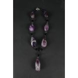 An unusual necklace made up of large rough cut Blue John drops interspaced with small black and